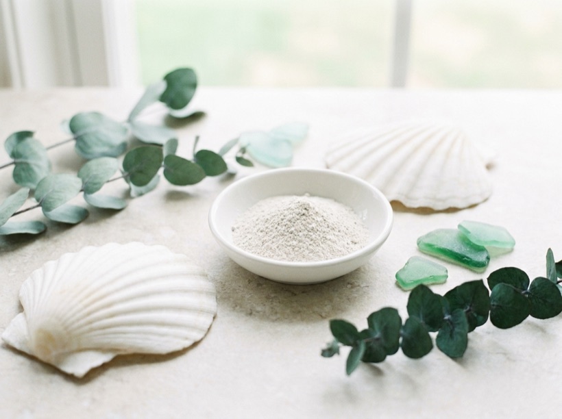 Scallop shells beside a dish of the mineral powder
