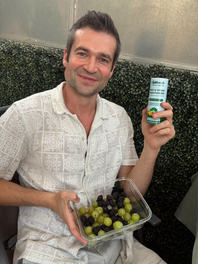 A customer with O'pHresh and a glass bowl of fresh grapes and blackberries